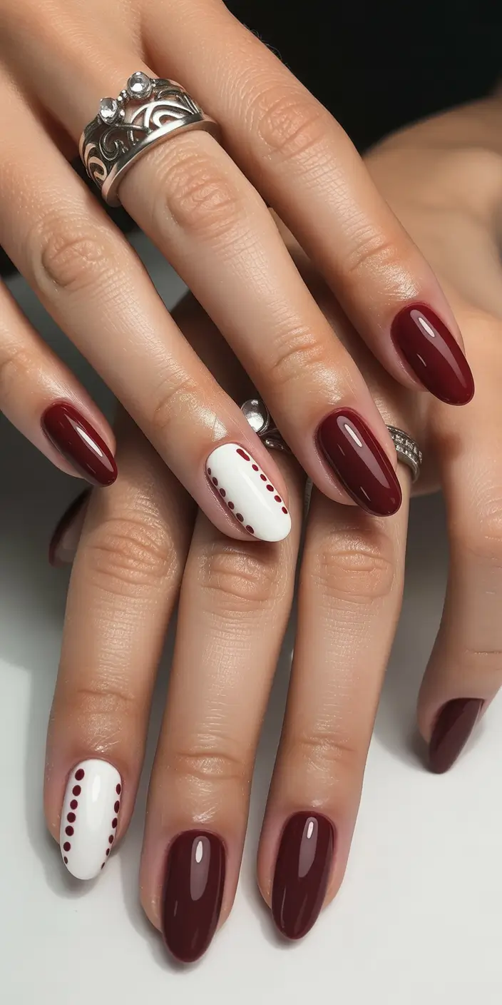 short almond nails Deep Burgundy with Graphic Dot Accents