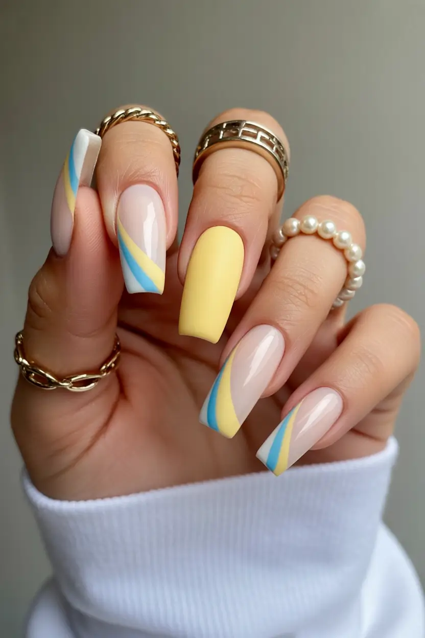 vibrant cute spring nails 2026 Pastel Yellow and Blue Diagonal Spring Coffin Blend