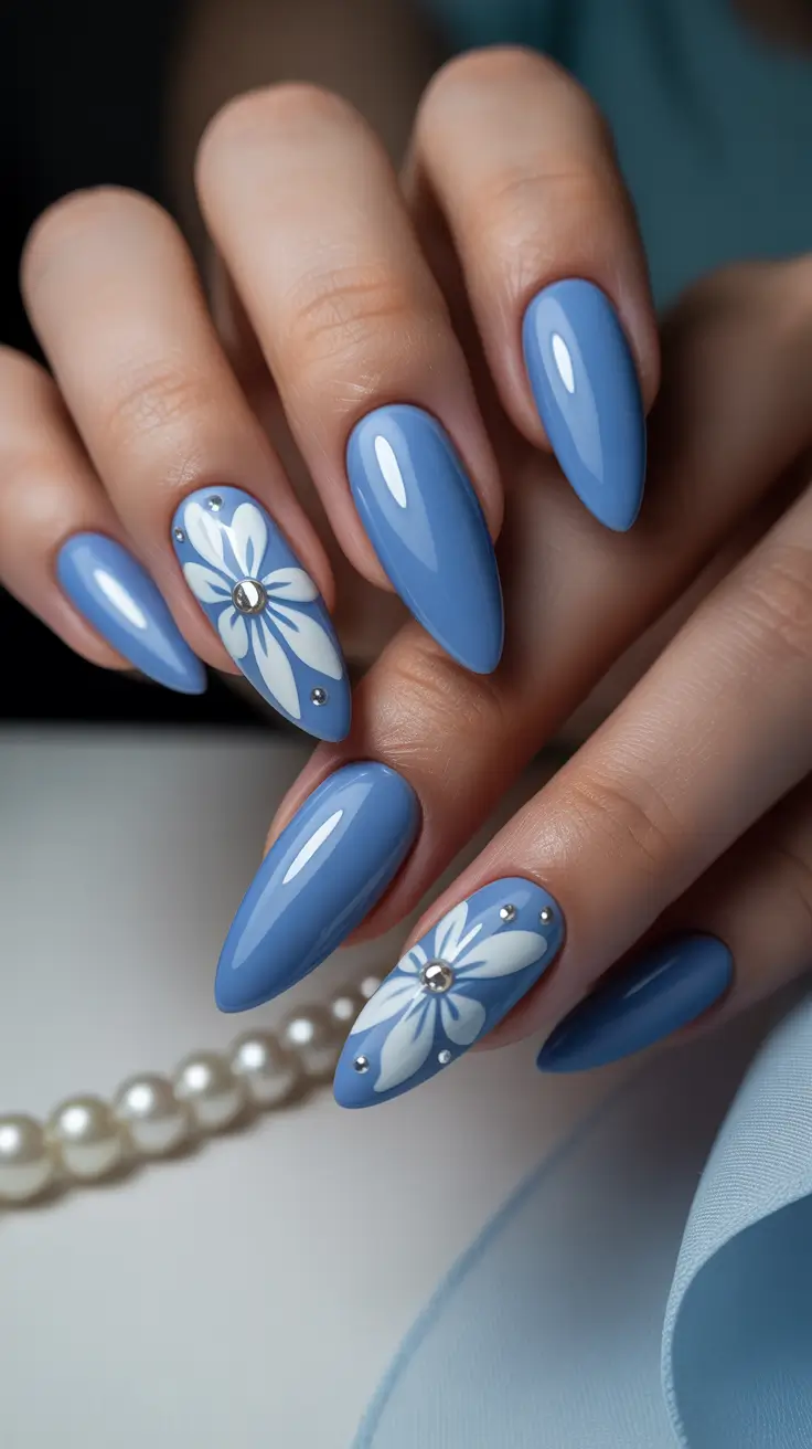 May Nails Ideas 2026 Glossy Blue Almond Nails with Minimal Floral Accent