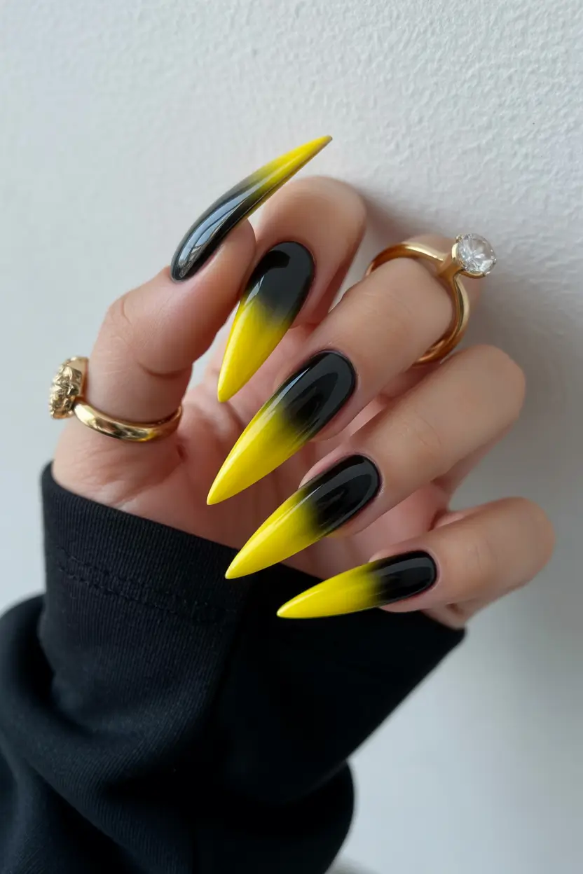 spring to summer season nails color ideas 2026 Electric Yellow and Black Ombre Stiletto Nails for Bold Contrast