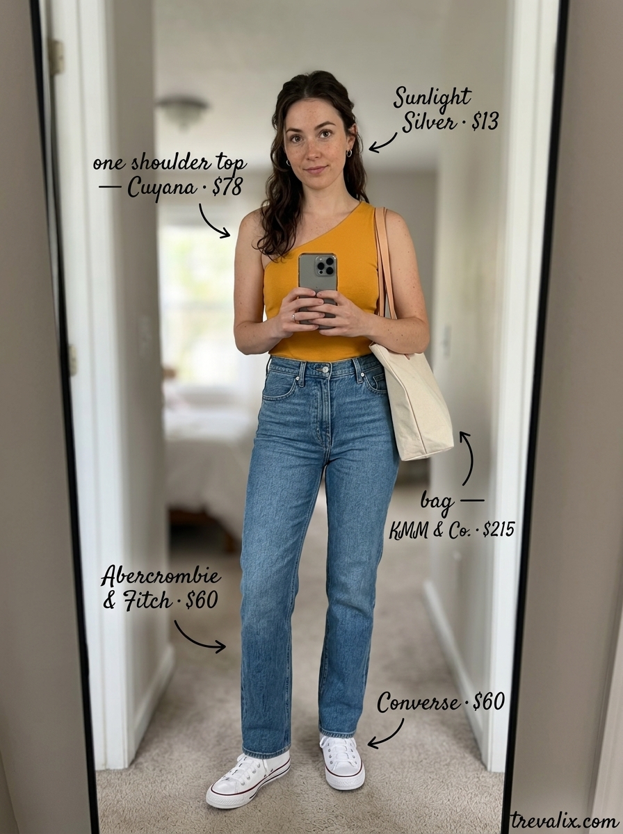 Casual Cool one shoulder t-shirt outfit for women 2026: Mustard yellow top, denim jeans, silver hoops.