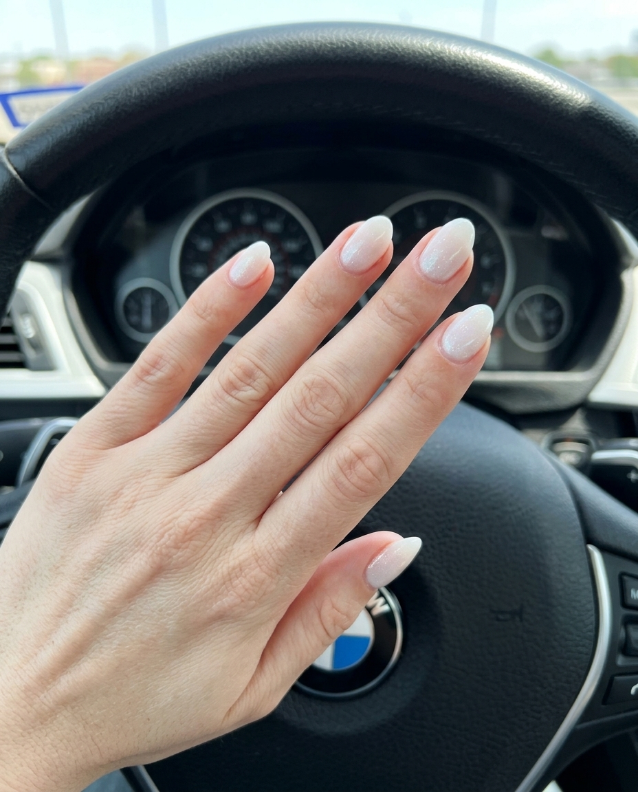 Almond summer nails 2026 for fair skin: Minimalist opaque milky white with subtle iridescent shimmer.