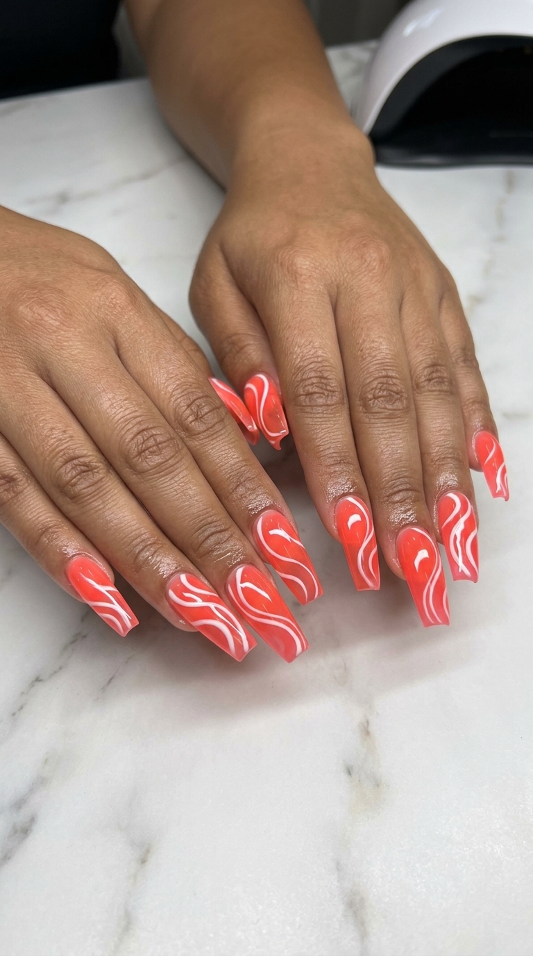 Cute summer nails 2026: Bright coral jelly swirls coffin for festivals and summer parties.