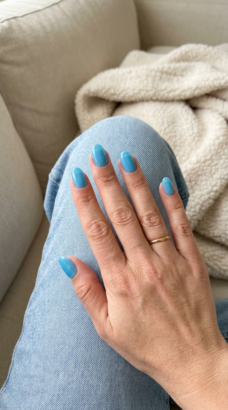 Crystal Clear Blue Jelly Oval nails: vibrant translucent light blue for playful summer 2026 vacation looks.