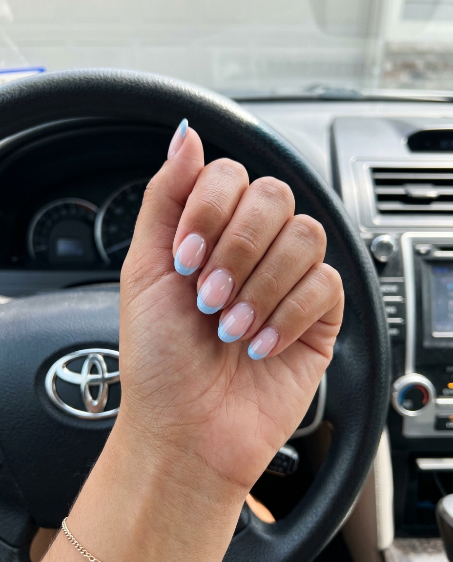 Ocean Breeze French nails: sheer nude base with light blue French tips for refreshing summer 2026 looks.