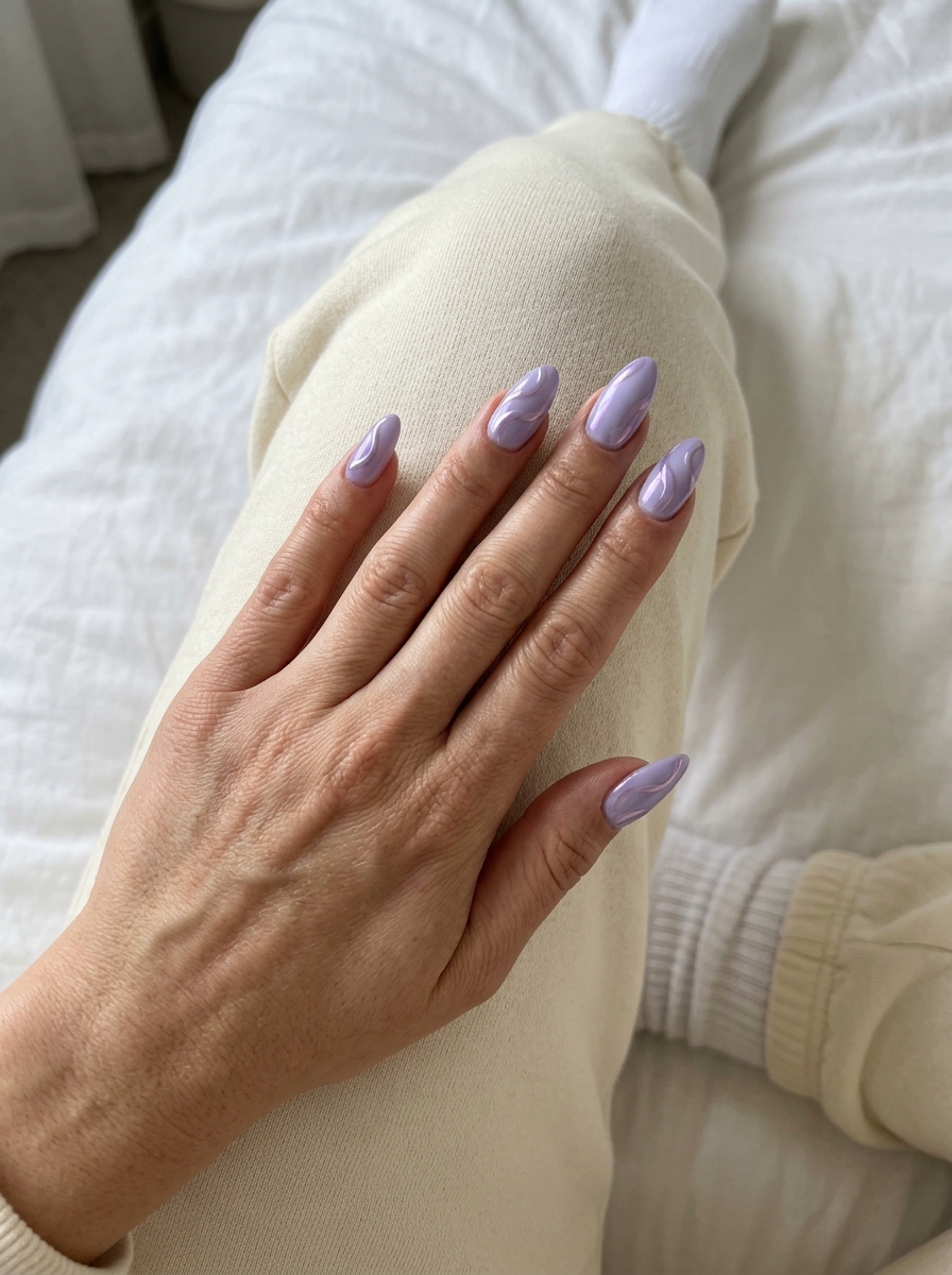 Shimmering Lavender Chrome Swirls nails: opaque lavender with iridescent lavender chrome swirls. Summer colorful nails designs 2026.