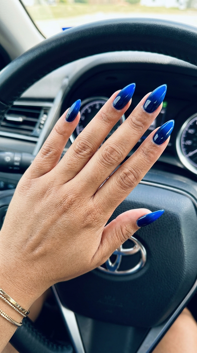 Futuristic deep navy to electric blue ombre stilettos for summer colorful nails designs 2026.