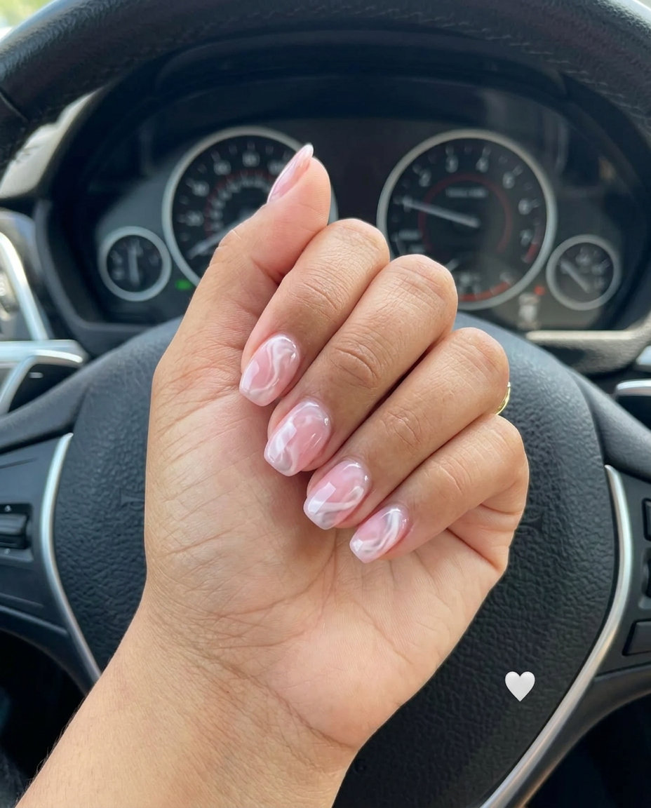 Sheer Pink Marble Swirl Nails 2026 Sheer pink marble swirl short simple summer gel nails 2026. Artistic and dreamy for romantic occasions.