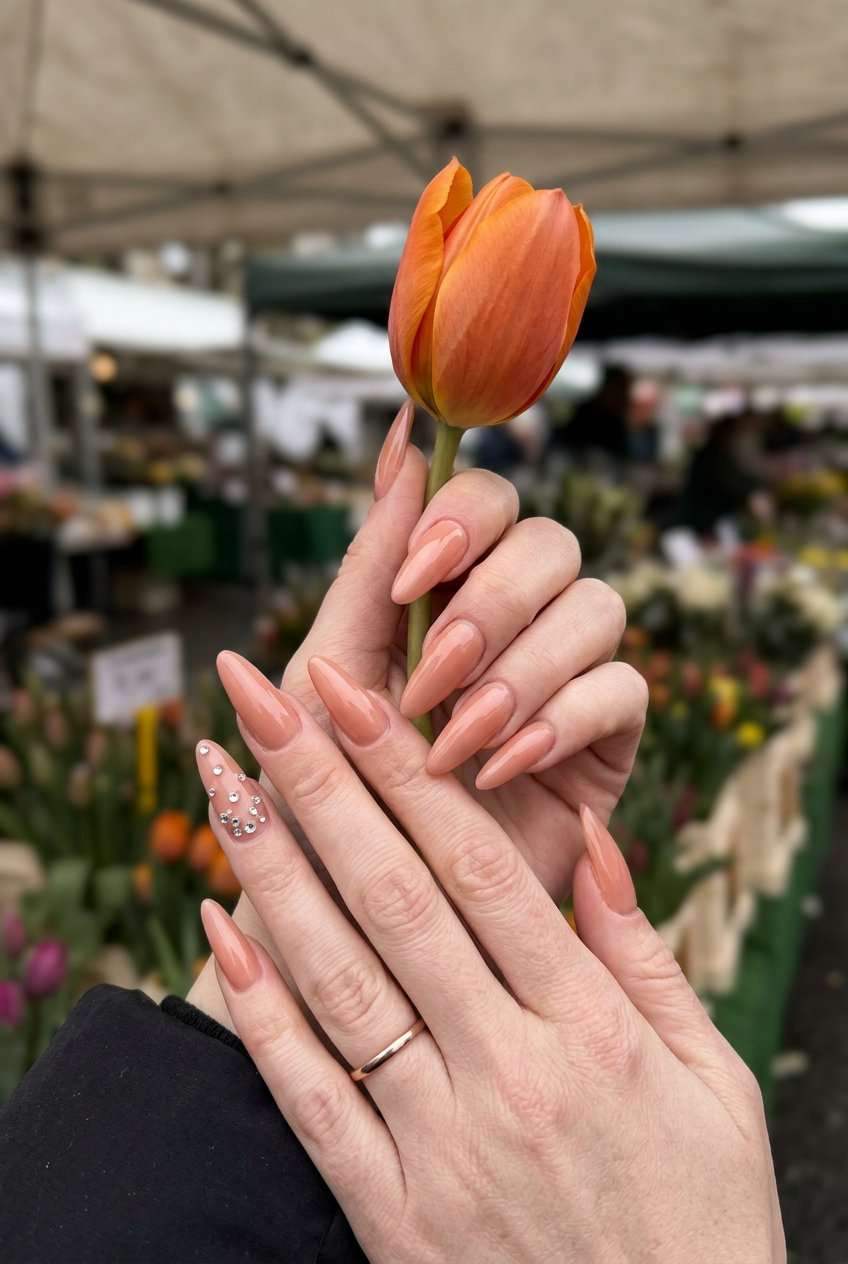 Glamorous Peach Crystal Accent Nails 2026 Peach crystal accent soft square nails for summer 2026, glamorous party look with muted peach and scattered rhinestones.