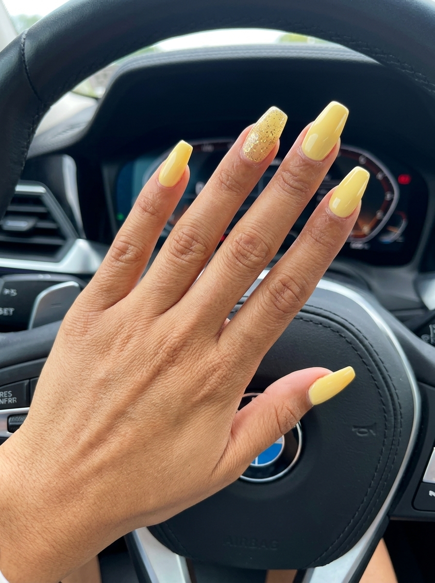 Butter Yellow Glitter Nails 2026: Chic Summer Party Butter yellow nails with gold glitter accents for a glamorous summer party in 2026.