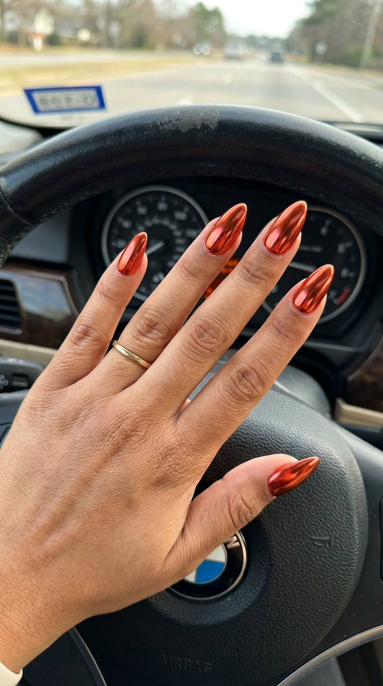 Futuristic metallic copper red chrome nails for summer red nails 2026 night outs.