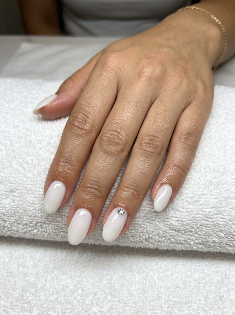Milky White Halo Nails 2026: Classic Wedding Glam Milky white rhinestone halo oval nails for summer wedding nails 2026. Glamorous, classic engagement photo manicure.