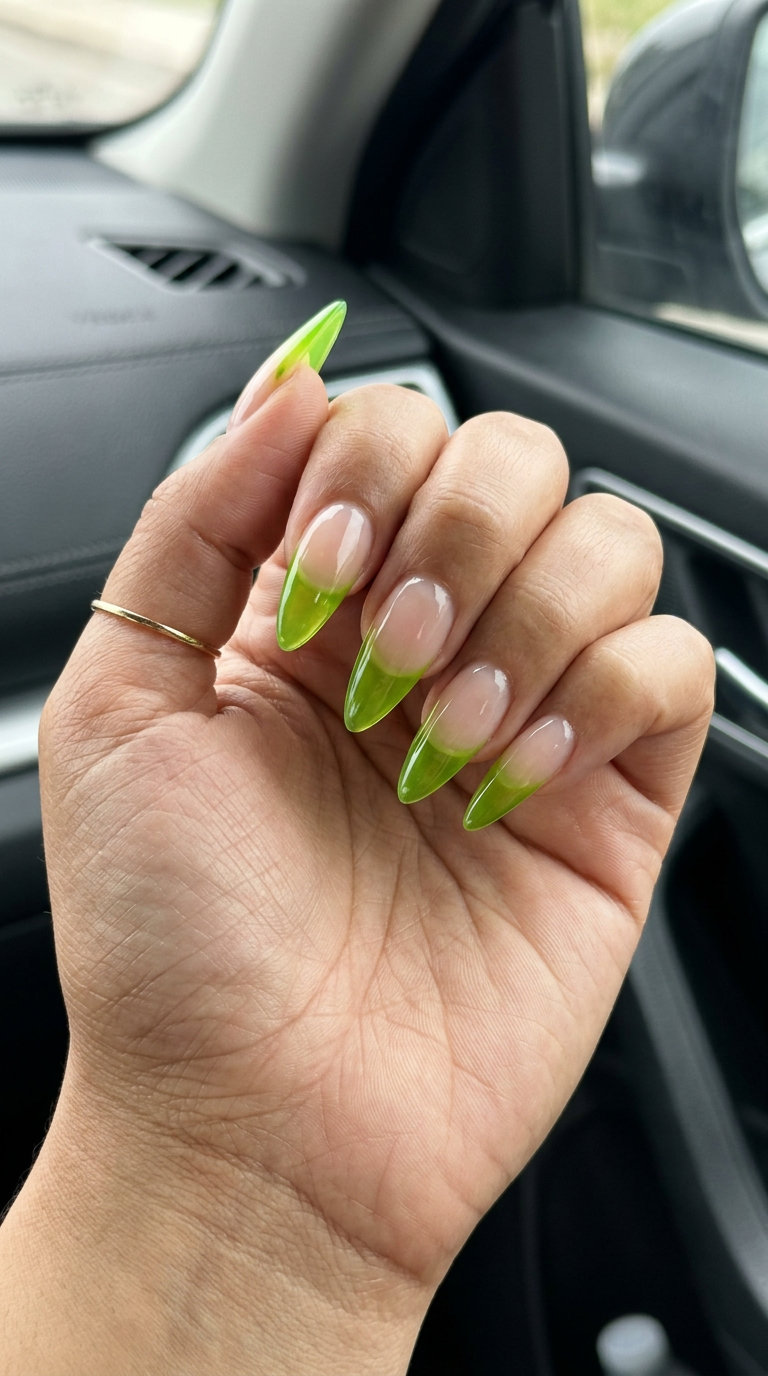 Edgy lime green jelly stiletto French nails for parties 2026. Bold translucent tips on long nails.