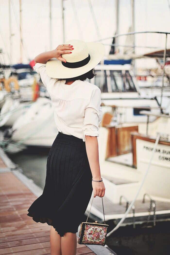 Black Pleated Midi Skirt with White Blouse and Straw Hat — Pleated Skirt Outfits 2027
