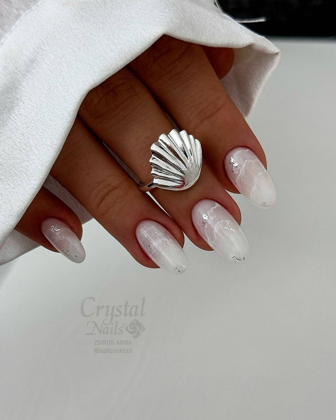 Milky Marble Swirls with Glitter Accents Milky Marble Swirls with Glitter Accents — Winter White Nails 2027