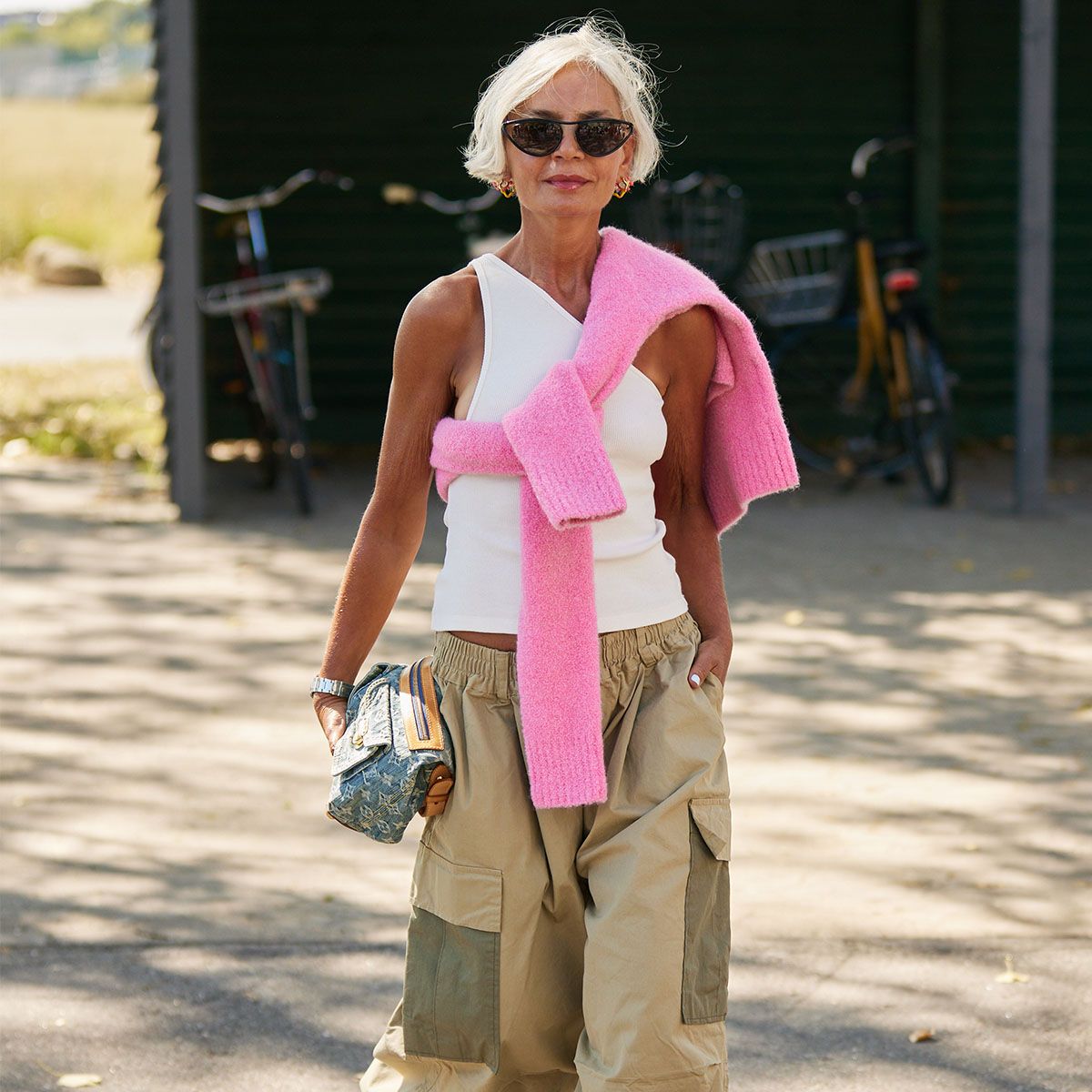 Khaki Cargo Pants with Pink Sweater Draped Over Shoulders Khaki Cargo Pants with Pink Sweater Draped Over Shoulders — Scandinavian Outfits 2027