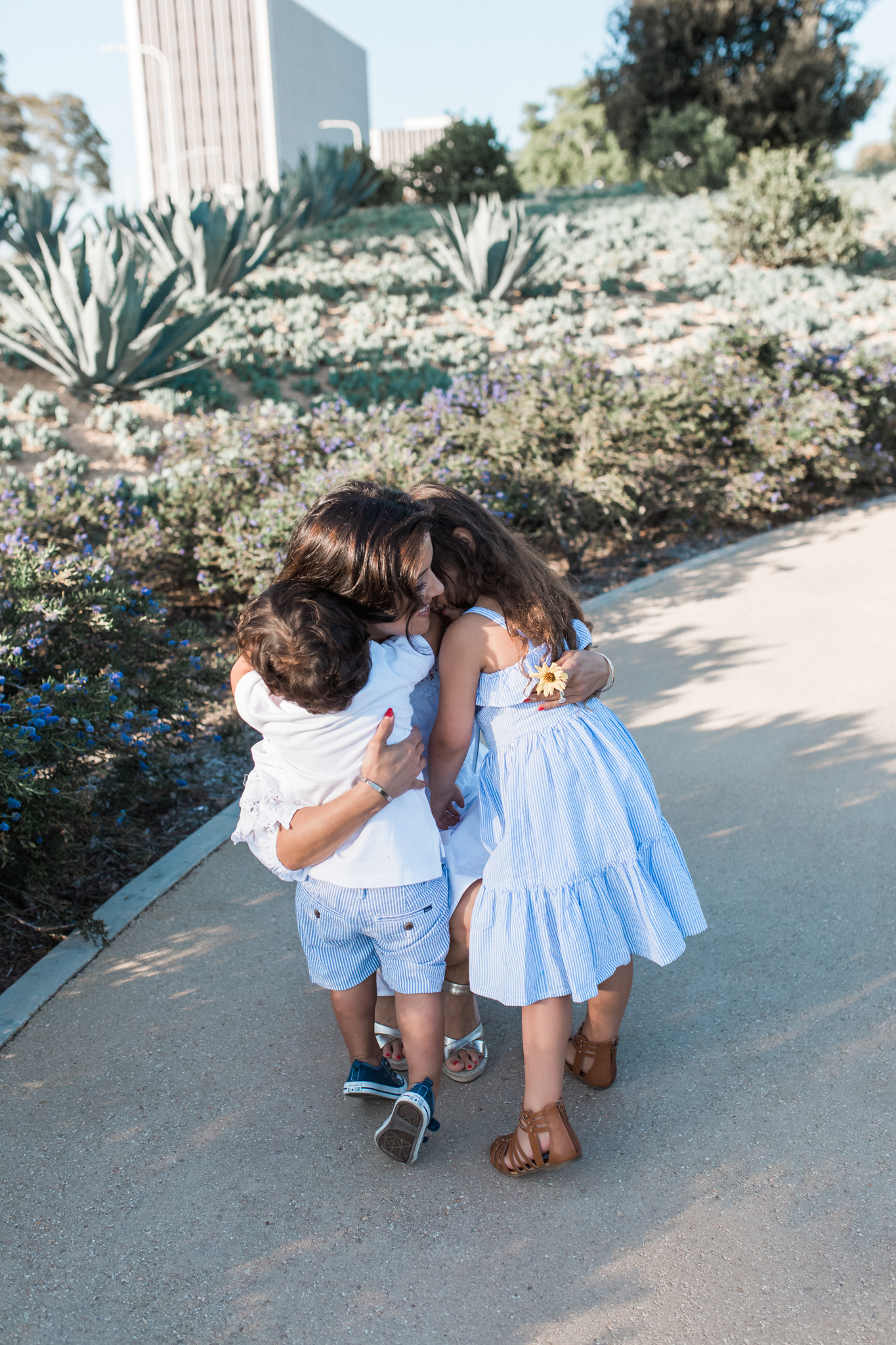 Blue and White Stripes with a Simple White Top for a Sweet Family Hug — Easter Family Photo Outfits 2027