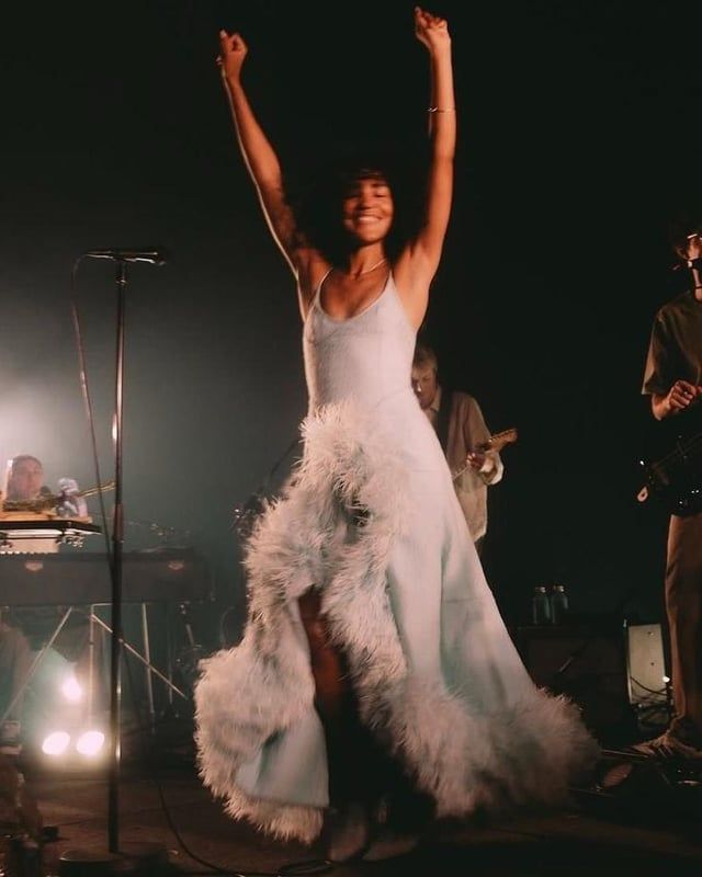 Light Blue Slip Dress with Feather Trim and Heeled Boots — Concert Outfits 2027