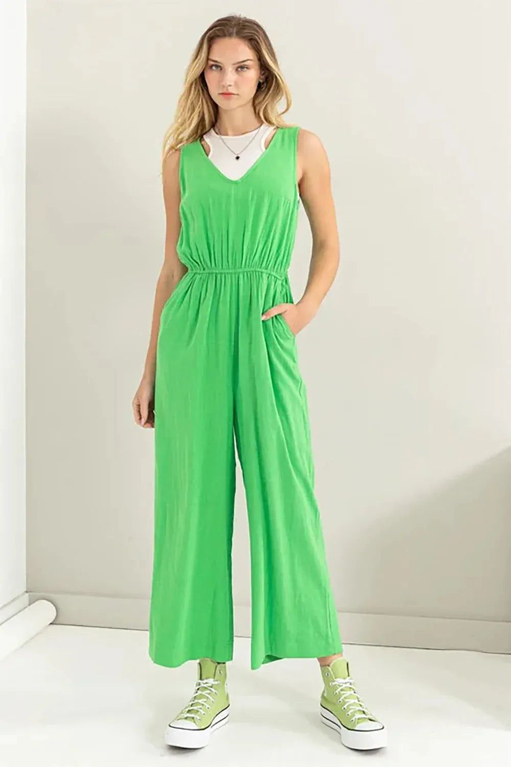 Bright Green Jumpsuit Layered Over White T-Shirt for Casual Style Bright Green Jumpsuit Layered Over White T-Shirt for Casual Style — Sleeveless Jumpsuit Outfits 2027