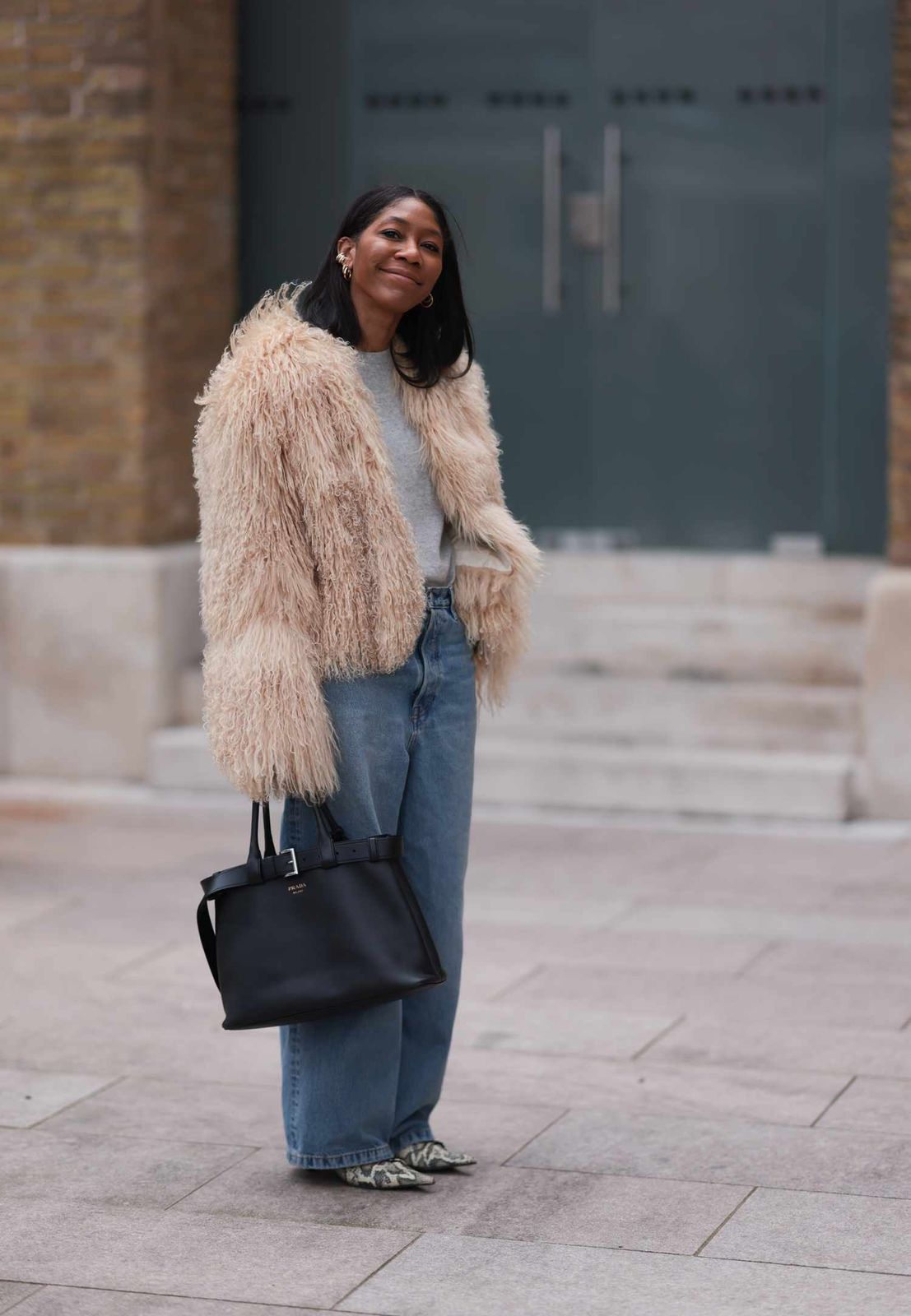 Shaggy Faux Fur Jacket Over a Grey Sweater and Blue Jeans Shaggy Faux Fur Jacket Over a Grey Sweater and Blue Jeans — Winter Outfits Warm Climate 2027