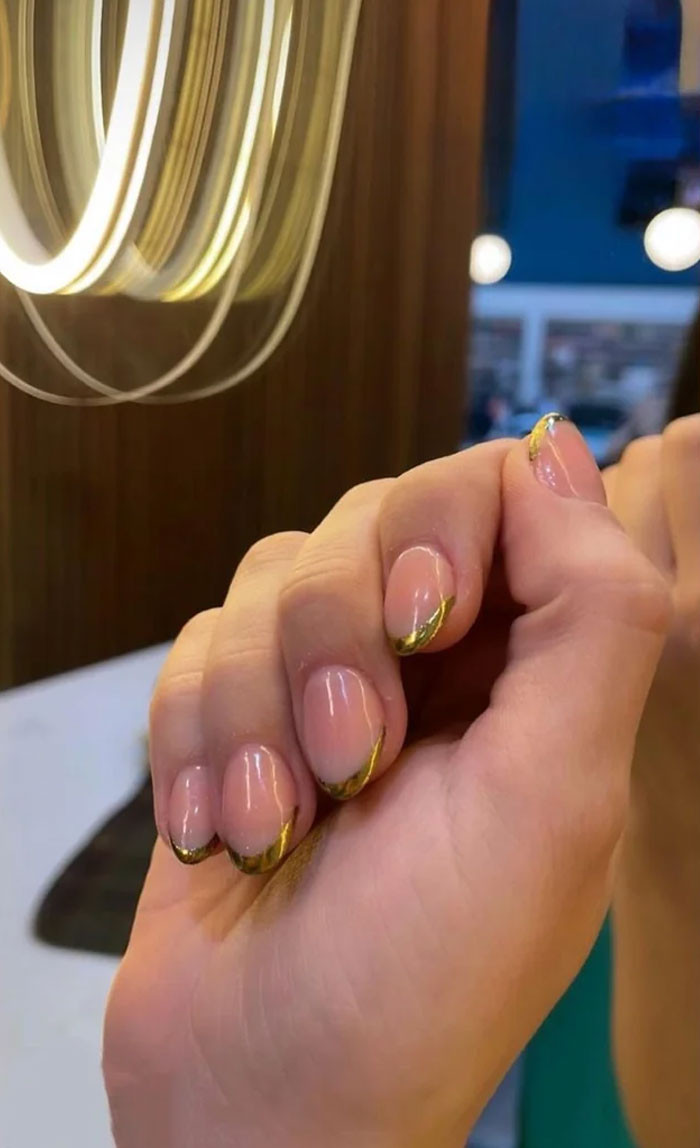 Sheer Nude Oval with Curved Gold Line — Short Gold French Tip Nails 2027
