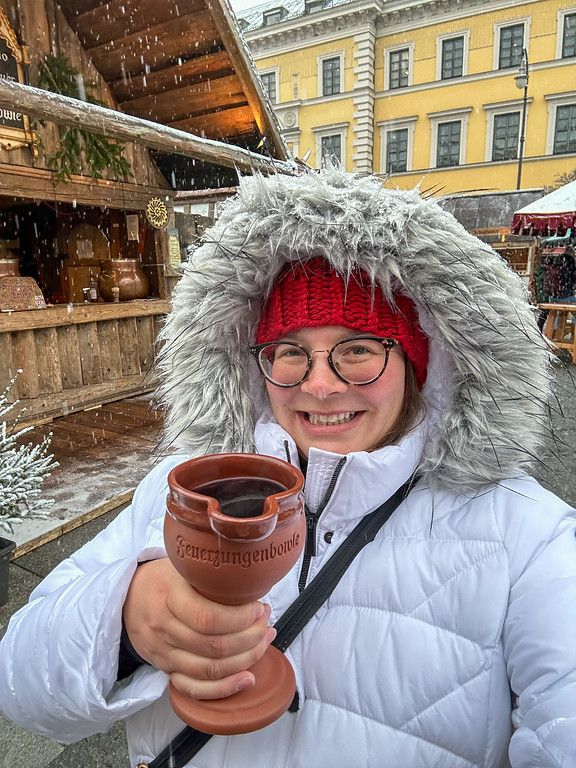 White Puffer Coat with Fur Hood and Red Beanie for Festive Cheer — Christmas Market Outfits 2026