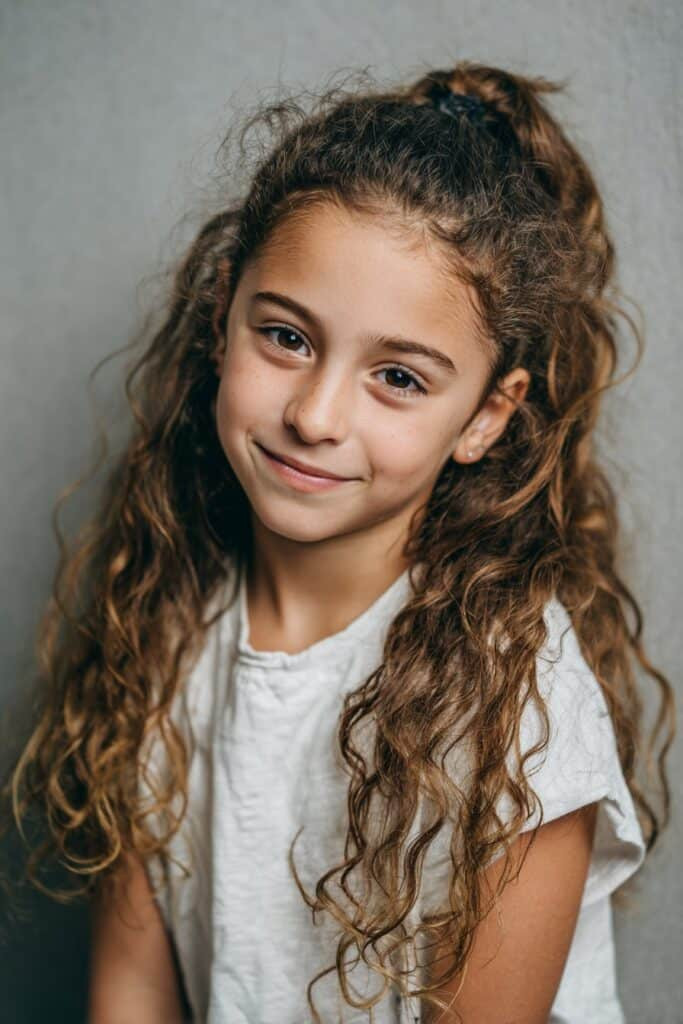 High Ponytail with Voluminous Curls — School Hairstyles 2027 for Mixed Hair