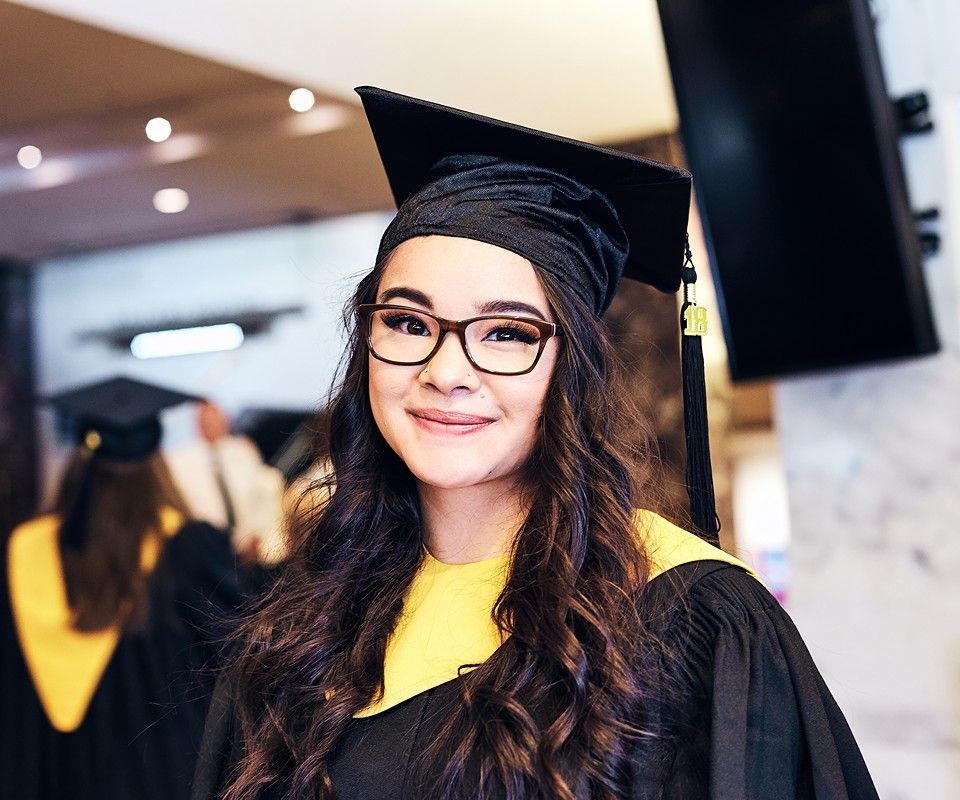 Black Graduation Gown with Yellow Accents and Glasses — Graduation Speaker Outfits 2027