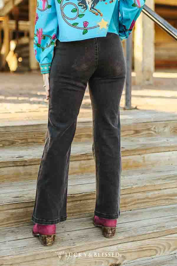 Black Bootcut Jeans with Pink Boots and Patterned Shirt — Black Bootcut Jeans Outfits 2027