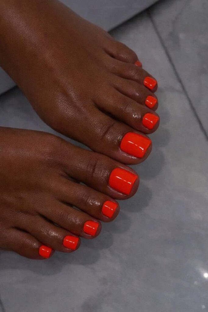 Vibrant Glossy Orange Pedicure — Toe Nails 2027 for Tan Skin