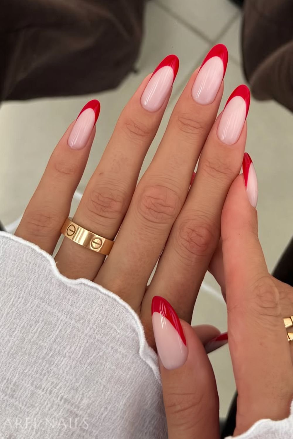 Classic Red French Medium Almonds — The Glossy Finish Reflects Soft Light — Red French Tip Nails 2027