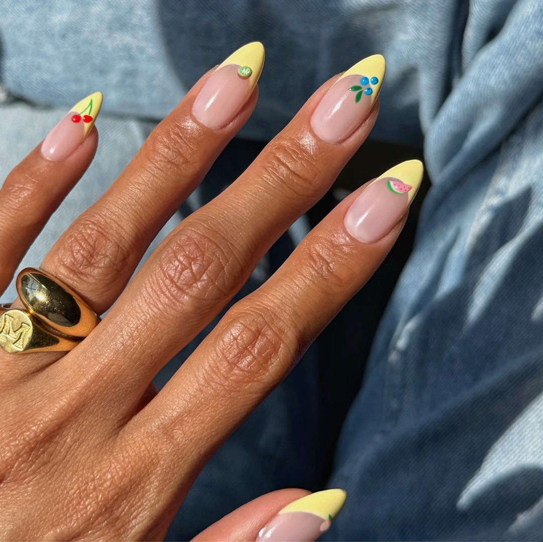 Yellow French Tips With Tiny Fruit Accents Yellow French Tips With Tiny Fruit Accents — Summer Almond Nails 2027