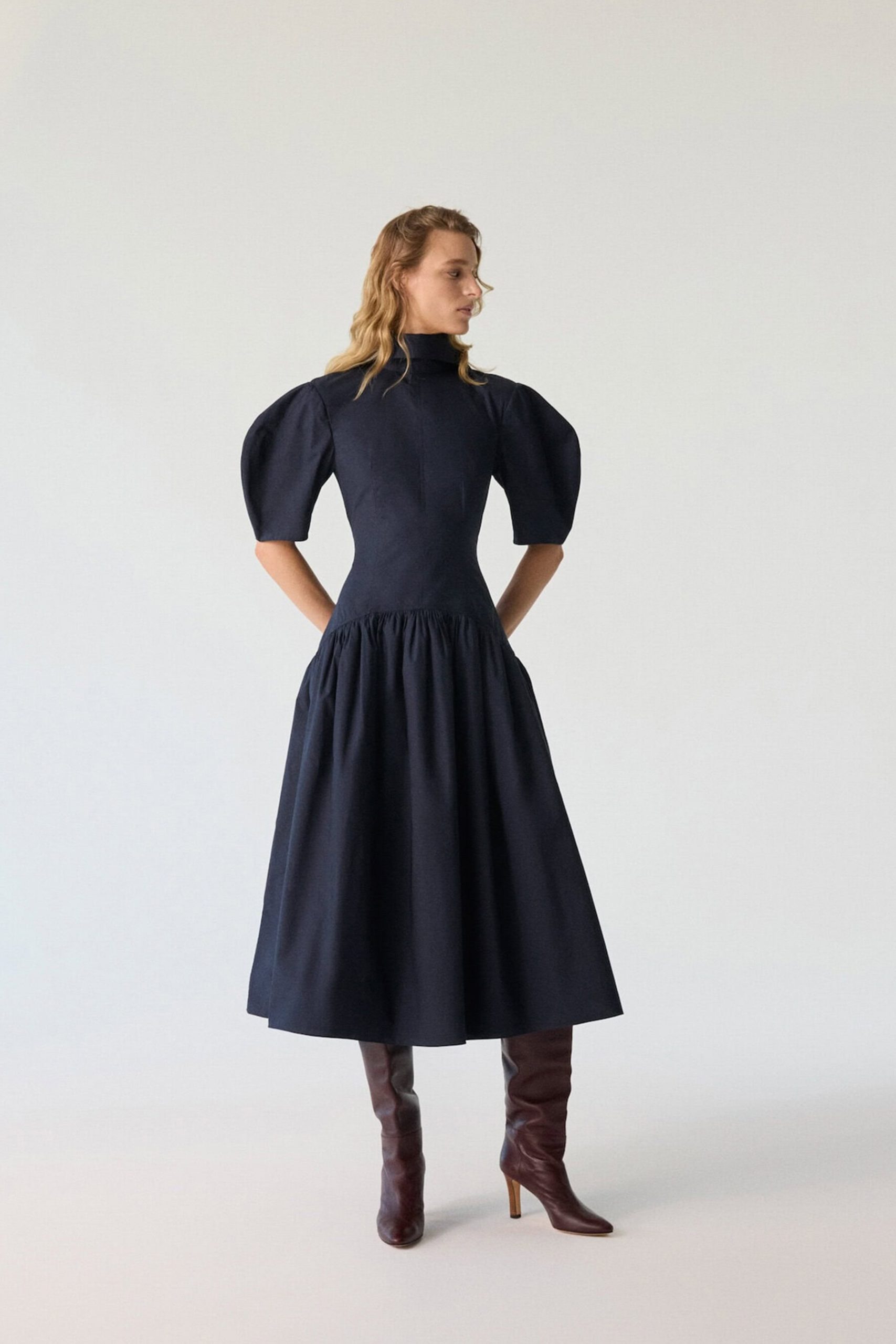 Structured Puff Sleeves Elevate a Dark Blue Midi Dress Structured Puff Sleeves Elevate a Dark Blue Midi Dress — Puff Sleeve Dress Outfits 2027