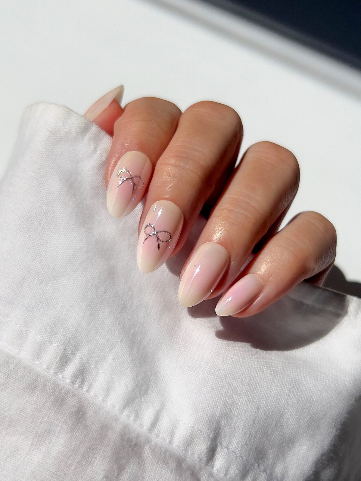 Medium Oval Sheer Nude Silver Bows Medium Oval Sheer Nude Silver Bows — Simple Bow Nails 2027