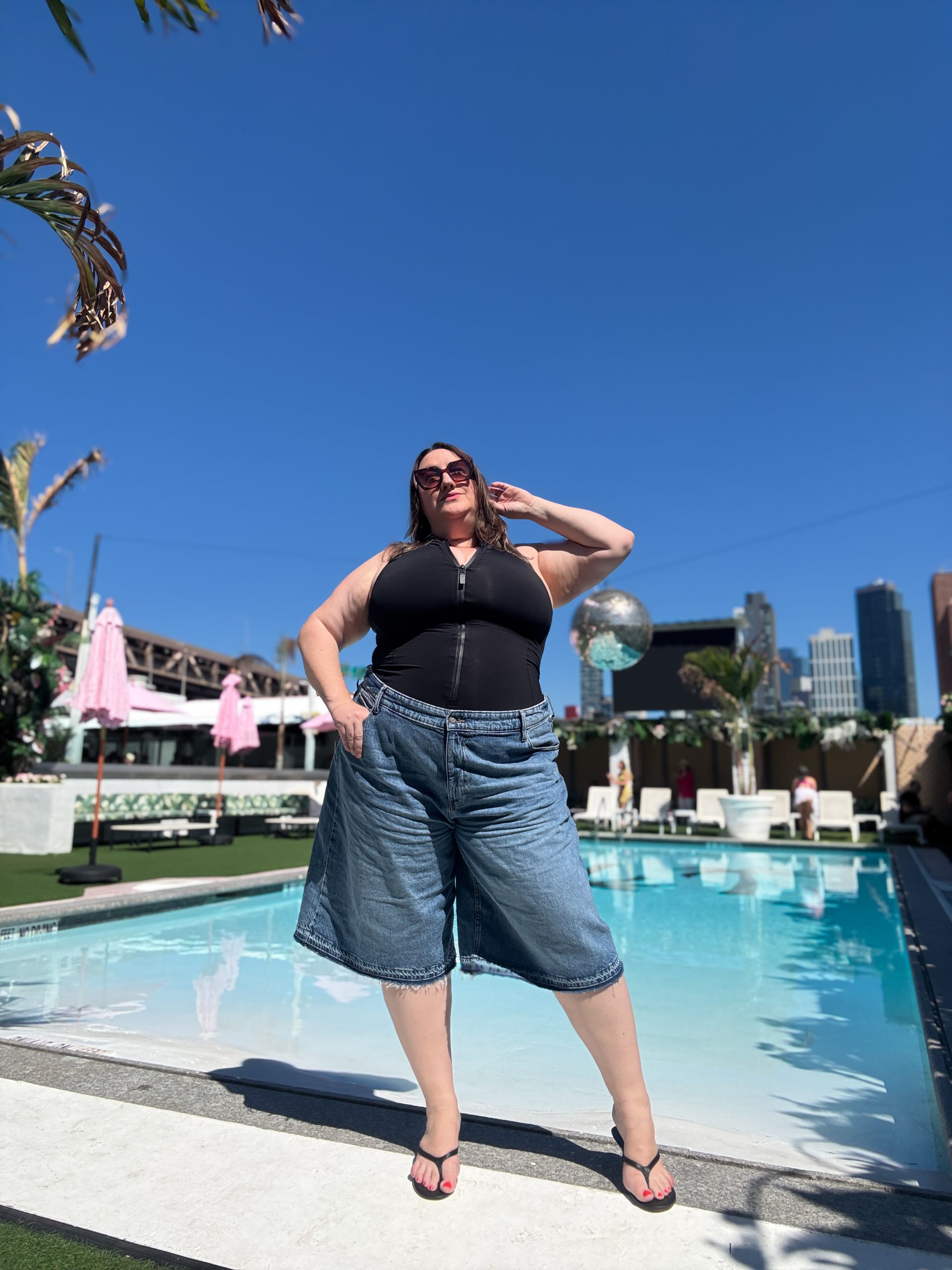 Black Zippered Bodysuit and Denim Culottes for a Trendy Poolside Look Black Zippered Bodysuit and Denim Culottes for a Trendy Poolside Look — Pool Party Outfits 2027