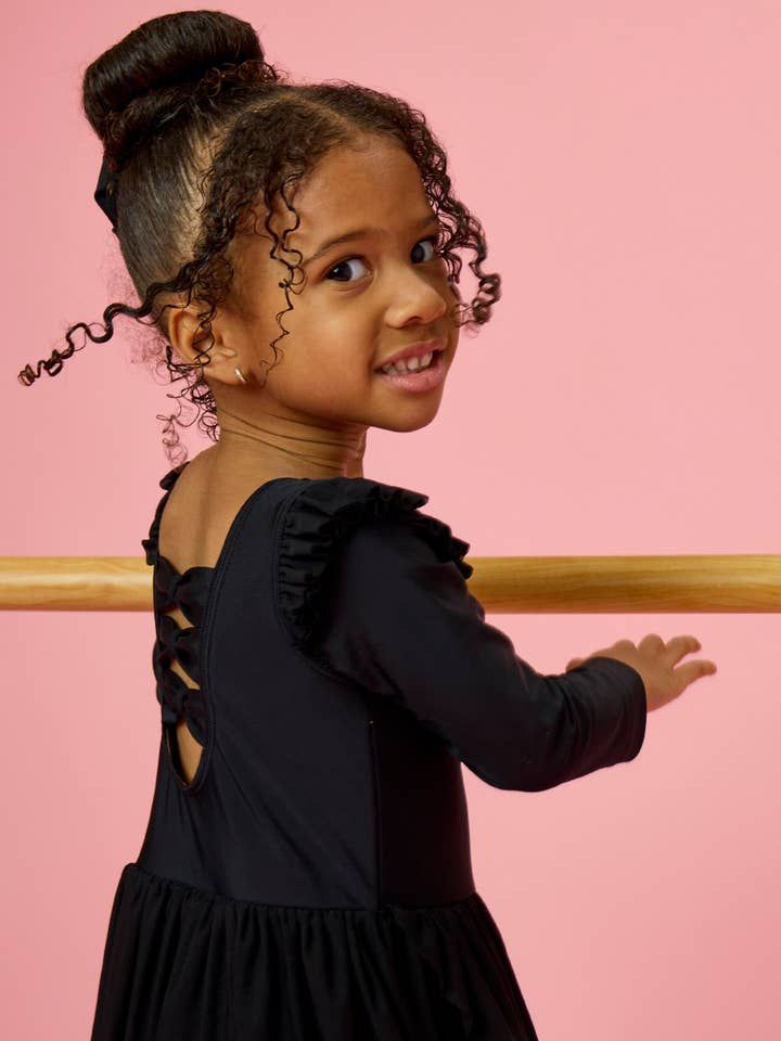 High Bun with Black Bow — Little Girl Gymnastics Hairstyles 2027