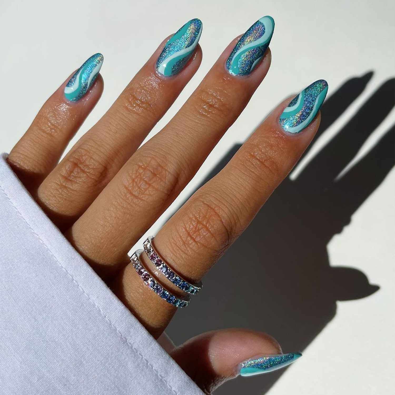 Shimmering Teal Swirl Almond Nails Shimmering Teal Swirl Almond Nails — Swim Nails Team Colors 2027