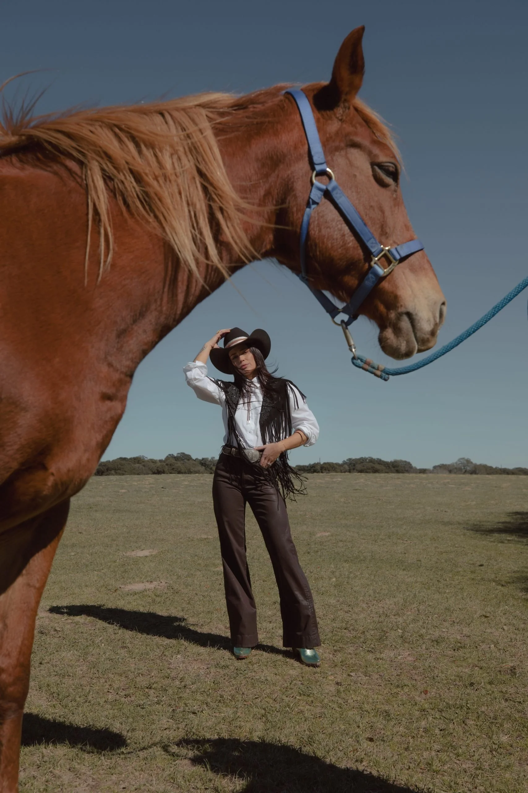 Fringed Vest Over White Shirt with Teal Boots Fringed Vest Over White Shirt with Teal Boots — Rodeo Outfits 2027