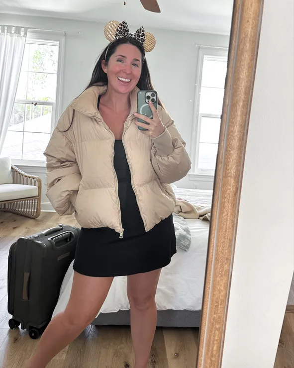Oversized Beige Puffer Jacket with Black Dress — Disney Winter Outfits 2027