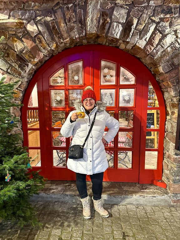 White Puffer Coat and Red Beanie for a Cheerful Market Day — Christmas Market Outfits 2026