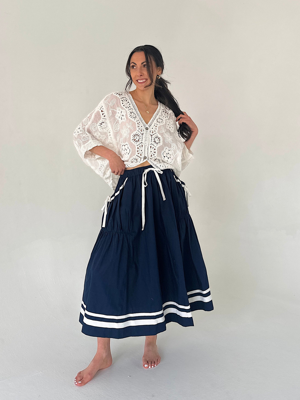 Tiered Midi Skirt with White Lace Blouse and Barefoot Styling Tiered Midi Skirt with White Lace Blouse and Barefoot Styling — Navy Blue Midi Skirt Outfits 2027