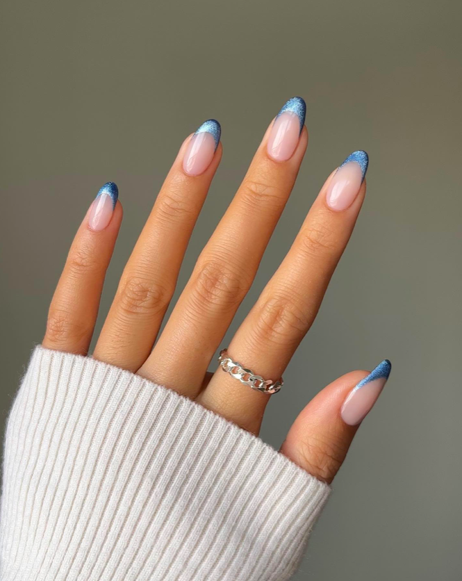 One Hand Sheer Nude Blue Glitter French Tips One Hand Sheer Nude Blue Glitter French Tips — Blue Christmas Nails 2026