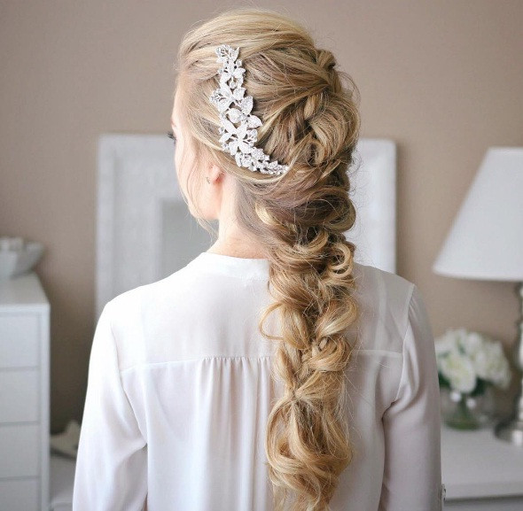 Loose Fishtail Braid With Floral Accessory Loose Fishtail Braid With Floral Accessory — Prom Hairstyles 2027 with Weave