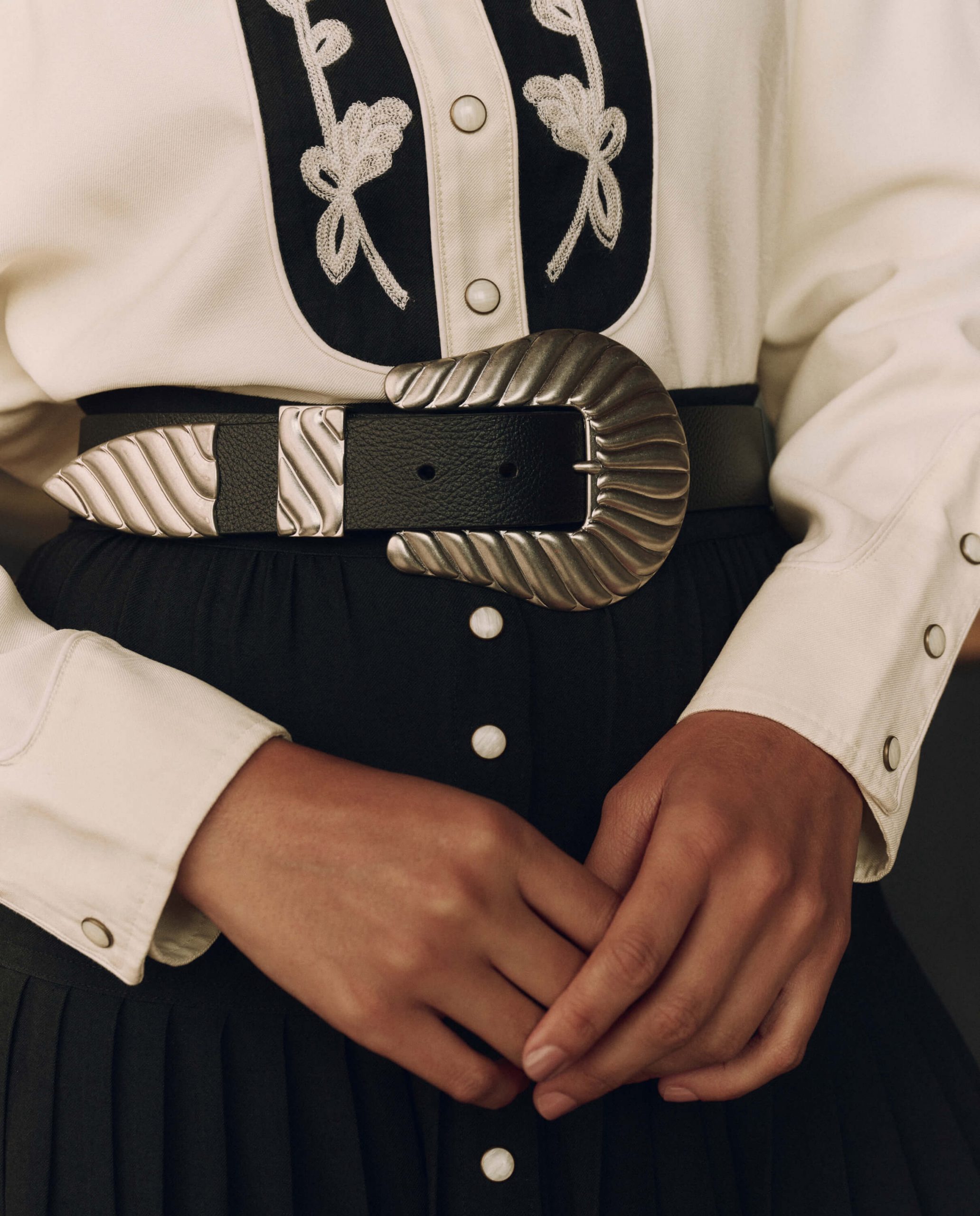 Black Skirt and White Shirt Paired with a Textured Silver Buckle Belt Black Skirt and White Shirt Paired with a Textured Silver Buckle Belt — Western Belt Outfits 2027