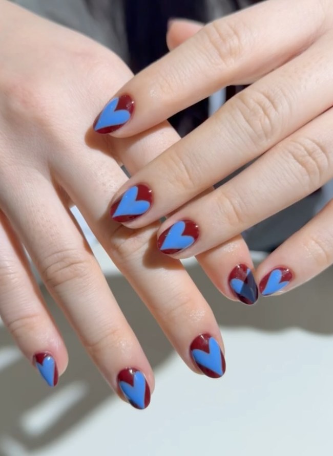 Moody Matte Black Oval with Hearts — Both Hands Are Shown Mismatched Heart Nails 2027