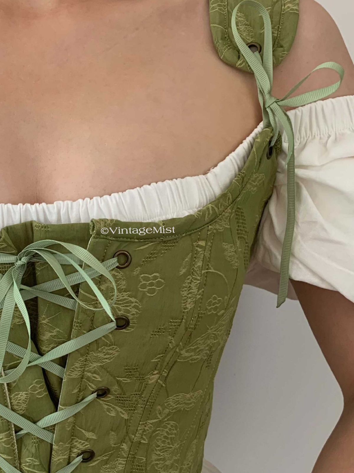 Vintage Casual: Green Lace-Up Corset Over a Puff-Sleeve Blouse Vintage Casual: Green Lace-Up Corset Over a Puff-Sleeve Blouse — Coquette Corset Top Outfits 2027