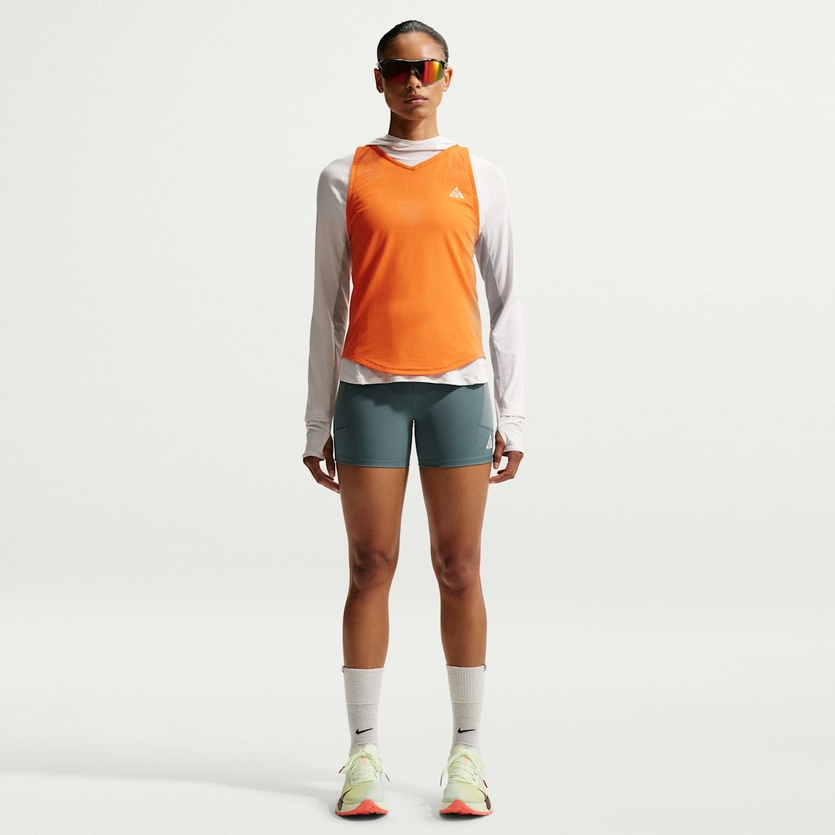 Layered Bright Orange Top with Teal Shorts and Neon Sneakers — Athletic Hiking Outfits 2027