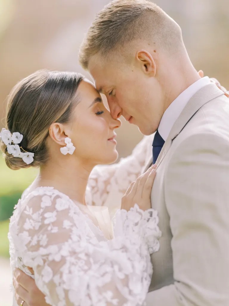 Low Chignon With Soft Waves and Flowers — Wedding Updos 2027