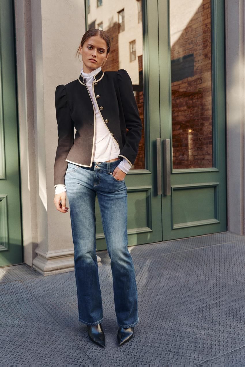 Black Jacket with Gold Trim and White Turtleneck with Blue Bootcut Jeans Black Jacket with Gold Trim and White Turtleneck with Blue Bootcut Jeans — Blue Bootcut Jeans Outfits 2027