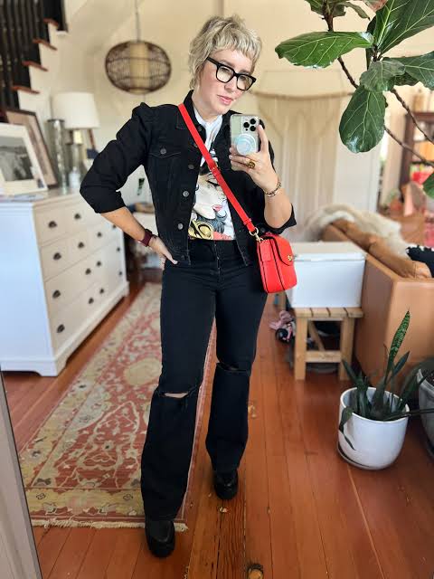 Bold Contrast: Flared Jeans with Graphic Tee and Red Bag Bold Contrast: Flared Jeans with Graphic Tee and Red Bag — Black Jeans Outfits 2027